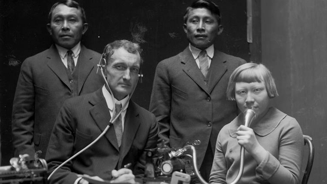 J. P. Harrington posing with three Cuna (Tule) people while making Dictaphone recordings of Cuna language and songs, 1924. [BAE GN 4305 A, National Anthropological Archives, Smithsonian Institution. Photo Credit: National Anthropological Archives, Smithsonian Institution